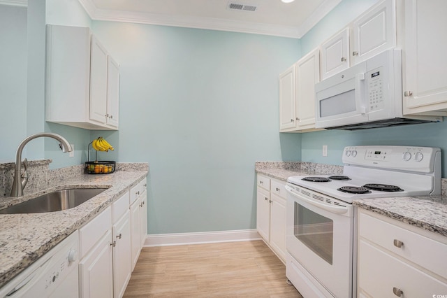 kitchen with white appliances, a sink, ornamental molding, baseboards, and light wood-type flooring