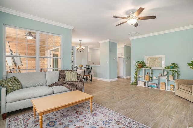living room featuring ornamental molding, ceiling fan, a chandelier, baseboards, and wood finished floors