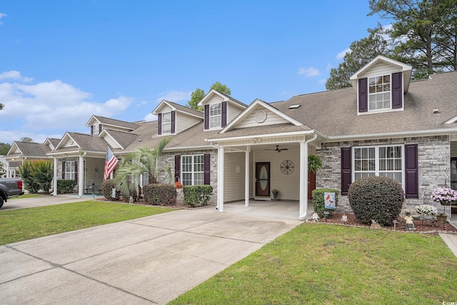 view of front facade with a front yard, driveway, brick siding, and a shingled roof