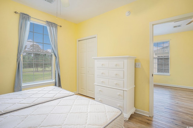488 River Oaks Dr Unit 61N, Myrtle Beach, SC 29579 - unfurnished bedroom with light wood-style floors, baseboards, a closet, and a ceiling fan
