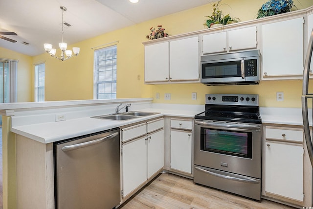488 River Oaks Dr Unit 61N, Myrtle Beach, SC 29579 - kitchen with stainless steel appliances, a sink, a peninsula, light wood finished floors, and light countertops