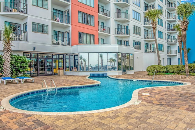 community pool featuring a patio area