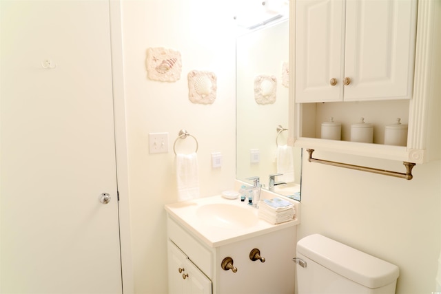 bathroom with toilet and vanity