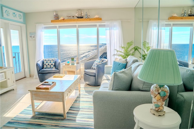 living room with light tile patterned floors and a water view