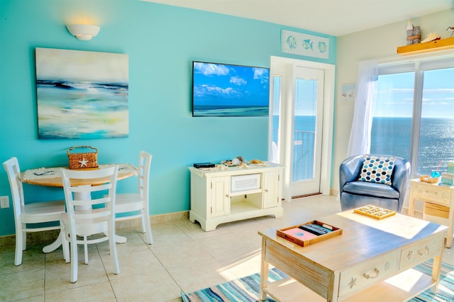 living area with light tile patterned floors and baseboards