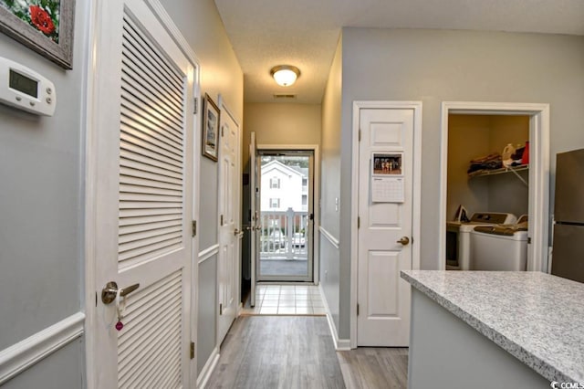 4811 Innisbrook Ct Unit 306, Myrtle Beach, SC 29579 - doorway with separate washer and dryer, wood finished floors, and baseboards