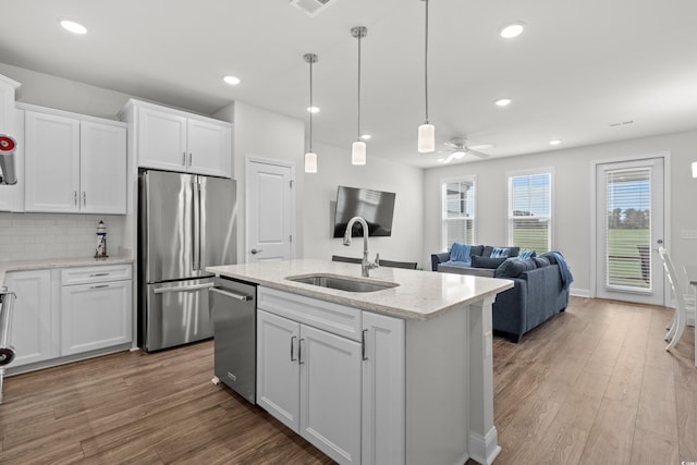 5127 Double Eagle Way Unit 11, North Myrtle Beach, SC 29582 - kitchen featuring appliances with stainless steel finishes, a sink, white cabinets, wood finished floors, and a ceiling fan