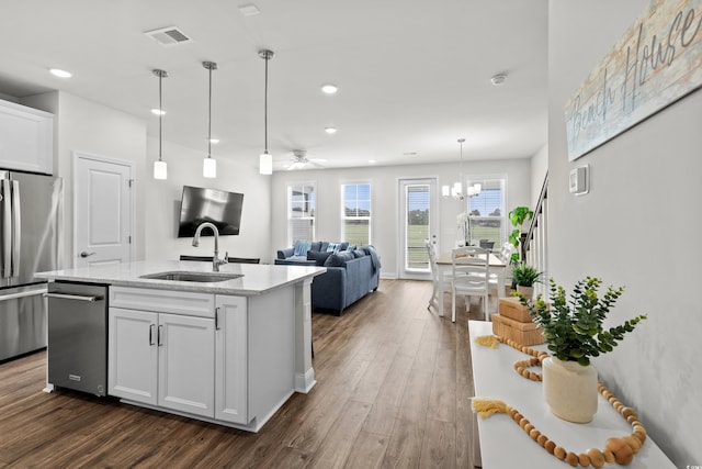 5127 Double Eagle Way Unit 11, North Myrtle Beach, SC 29582 - kitchen with a sink, appliances with stainless steel finishes, dark wood-style floors, light stone countertops, and white cabinets