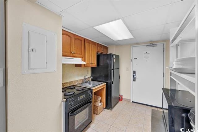 2401 S Ocean Blvd Unit 351, Myrtle Beach, SC 29577 - kitchen with range with electric cooktop, under cabinet range hood, freestanding refrigerator, electric panel, and brown cabinetry