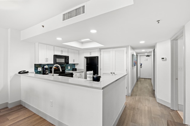 2301 S Ocean Blvd Unit 621, Myrtle Beach, SC 29577 - kitchen with black appliances, light wood-type flooring, baseboards, backsplash, and recessed lighting