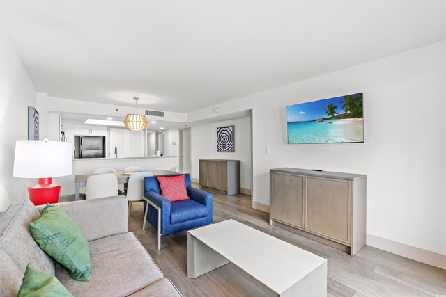 2301 S Ocean Blvd Unit 621, Myrtle Beach, SC 29577 - living room with light wood finished floors and baseboards