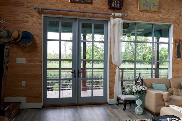 doorway featuring wood walls, french doors, and wood finished floors