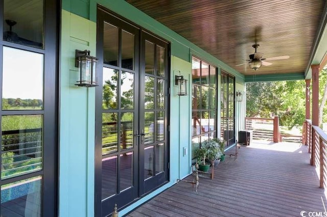 wooden deck featuring french doors and ceiling fan
