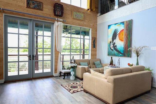 living room featuring wood finished floors, plenty of natural light, and a high ceiling