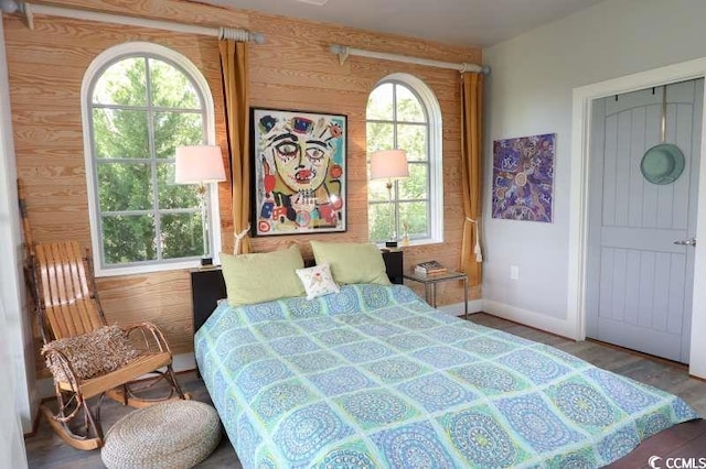 bedroom featuring baseboards and wood finished floors