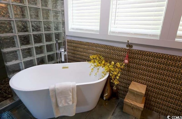 bathroom featuring a soaking tub