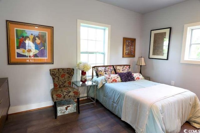 bedroom featuring dark wood-type flooring and baseboards