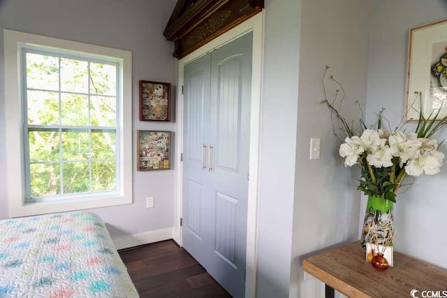 bedroom with baseboards and dark wood-style floors