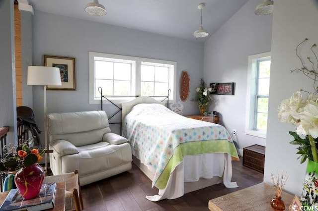 bedroom with wood finished floors and vaulted ceiling