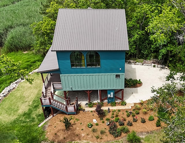 view of front of property with stairway and metal roof