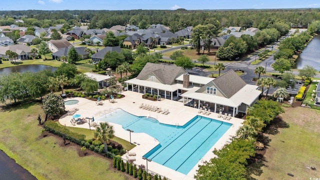 1325 Bermuda Grass Dr, Myrtle Beach, SC 29579 - aerial perspective of suburban area featuring a pool area and a nearby body of water