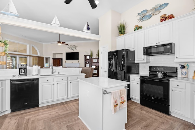 kitchen with black appliances, a ceiling fan, a sink, tasteful backsplash, and ornamental molding