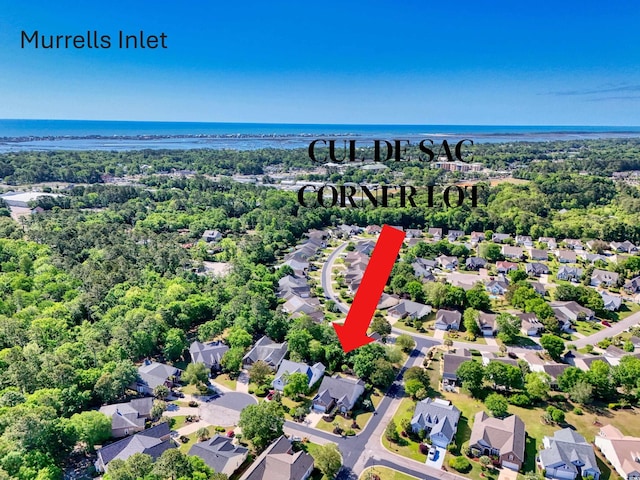 aerial perspective of suburban area with a large body of water