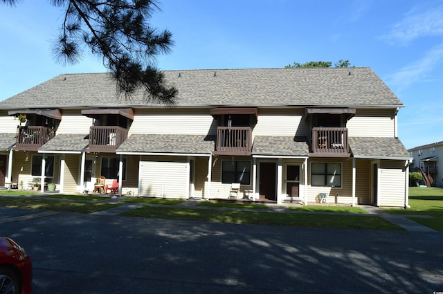 755 Burcale Rd Unit G8, Myrtle Beach, SC 29579 - view of front of house with a balcony, roof with shingles, and a front lawn