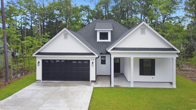 4120 Whatuthink Rd, Myrtle Beach, SC 29588 - modern farmhouse with a shingled roof, a porch, an attached garage, and a front lawn