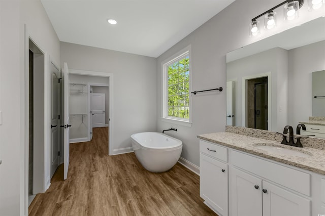 4120 Whatuthink Rd, Myrtle Beach, SC 29588 - full bath featuring wood finished floors, baseboards, a shower stall, a freestanding tub, and vanity