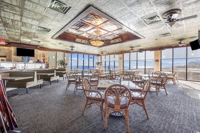 9400 Shore Dr Unit 509, Myrtle Beach, SC 29572 - dining room with carpet flooring, a ceiling fan, an ornate ceiling, and a wall of windows