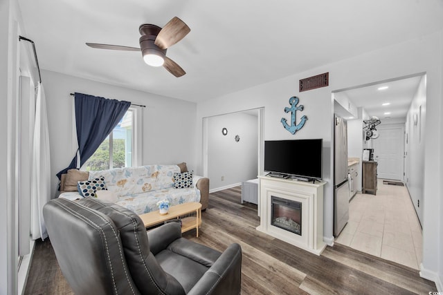9400 Shore Dr Unit 509, Myrtle Beach, SC 29572 - living area with a ceiling fan, wood finished floors, and baseboards