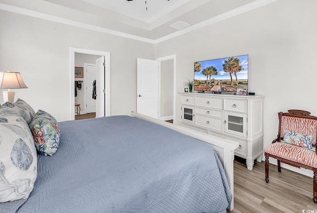 1340 Jolly Roger Dr, North Myrtle Beach, SC 29582 - bedroom with light wood-type flooring, crown molding, ceiling fan, and a tray ceiling