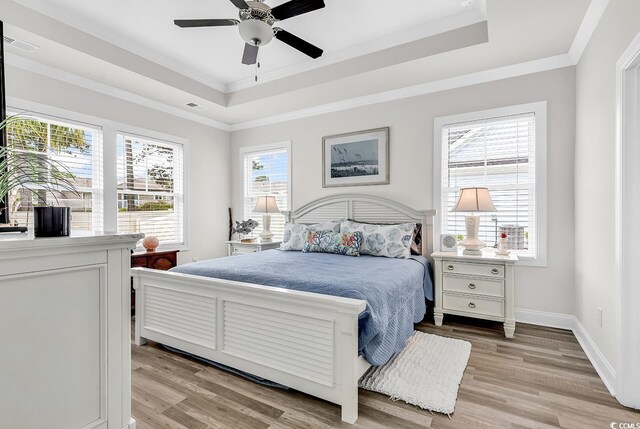1340 Jolly Roger Dr, North Myrtle Beach, SC 29582 - bedroom with a raised ceiling, light wood-style floors, ornamental molding, baseboards, and a ceiling fan