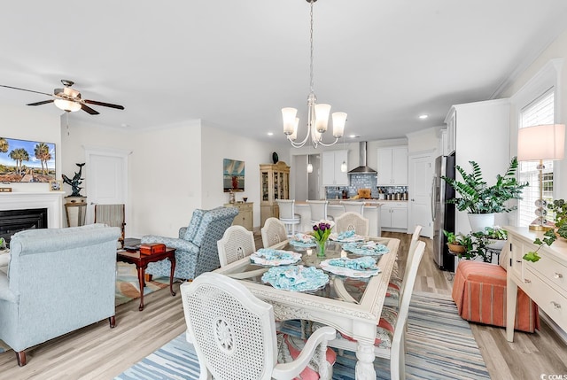 1340 Jolly Roger Dr, North Myrtle Beach, SC 29582 - dining room featuring a chandelier, light wood-style floors, recessed lighting, a ceiling fan, and a fireplace