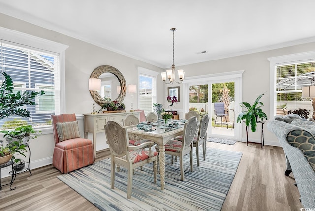1340 Jolly Roger Dr, North Myrtle Beach, SC 29582 - dining area featuring a chandelier, light wood-style floors, crown molding, and baseboards