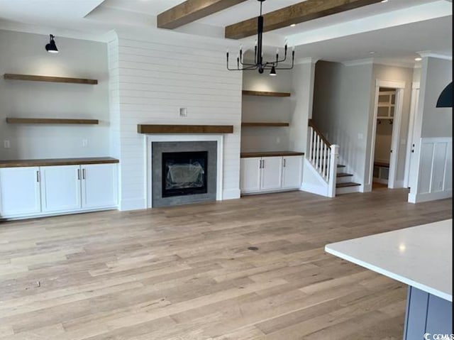 1142 Fiddlehead Way, Myrtle Beach, SC 29579 - unfurnished living room with a chandelier, light wood-style floors, stairway, ornamental molding, and beam ceiling