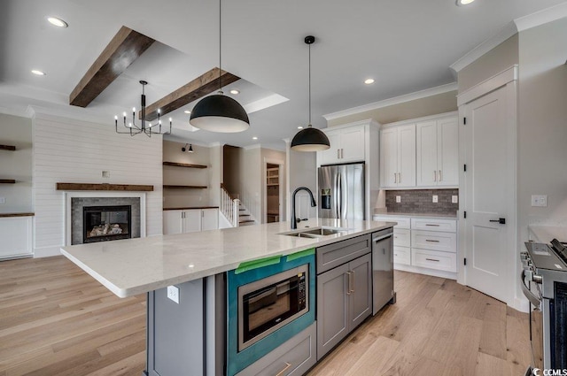 1142 Fiddlehead Way, Myrtle Beach, SC 29579 - kitchen featuring appliances with stainless steel finishes, a sink, white cabinets, ornamental molding, and light wood-style floors