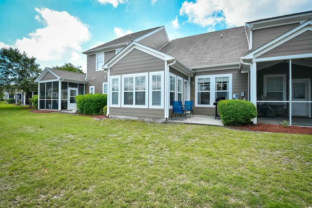 6172 Catalina Dr Unit 515, North Myrtle Beach, SC 29582 - back of house with a sunroom, a patio area, a yard, and roof with shingles