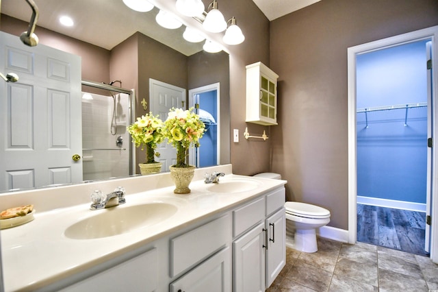 6172 Catalina Dr Unit 515, North Myrtle Beach, SC 29582 - full bathroom featuring a stall shower, double vanity, a chandelier, and a walk in closet