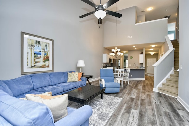 6172 Catalina Dr Unit 515, North Myrtle Beach, SC 29582 - living area with a chandelier, stairs, wood finished floors, a ceiling fan, and a high ceiling