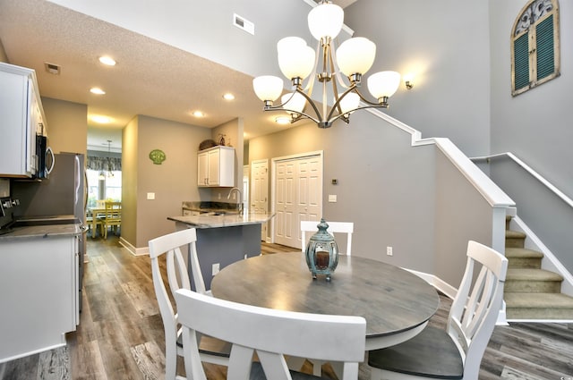 6172 Catalina Dr Unit 515, North Myrtle Beach, SC 29582 - dining area with a chandelier, dark wood-type flooring, recessed lighting, and stairway