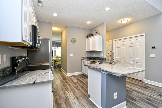 6172 Catalina Dr Unit 515, North Myrtle Beach, SC 29582 - kitchen with a peninsula, electric stove, stainless steel microwave, white cabinets, and dark wood finished floors