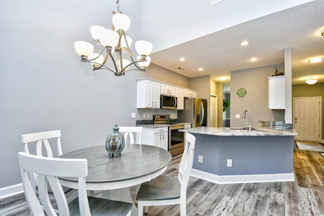 6172 Catalina Dr Unit 515, North Myrtle Beach, SC 29582 - dining space featuring wood finished floors, a chandelier, recessed lighting, and a textured ceiling