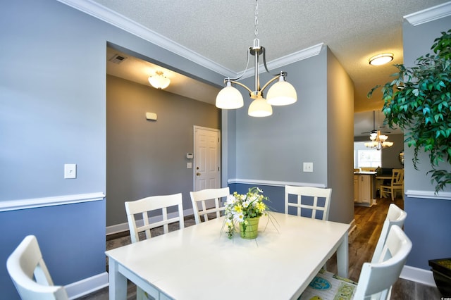 6172 Catalina Dr Unit 515, North Myrtle Beach, SC 29582 - dining area featuring a chandelier, crown molding, dark wood finished floors, and a textured ceiling