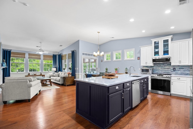 1444 Thames Ct, Myrtle Beach, SC 29577 - kitchen featuring stainless steel appliances, vaulted ceiling, a sink, white cabinetry, and healthy amount of natural light