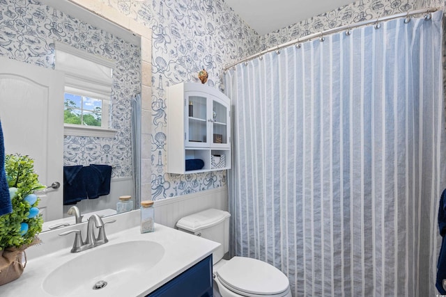 1444 Thames Ct, Myrtle Beach, SC 29577 - bathroom with wallpapered walls, a wainscoted wall, toilet, vanity, and a shower with curtain