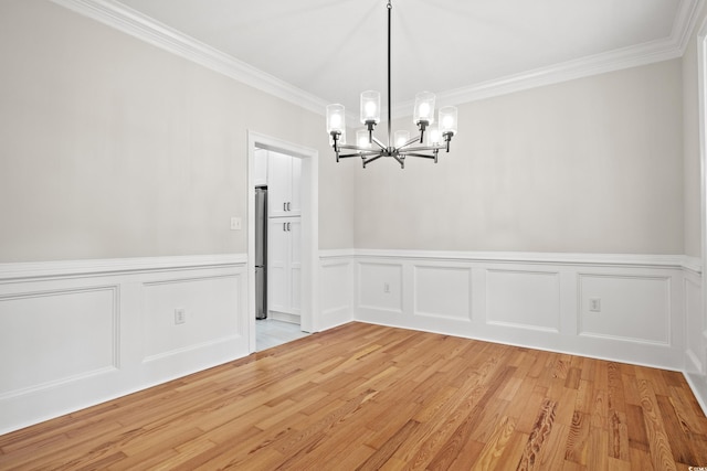 1533 Murrells Landing Rd, Conway, SC 29526 - unfurnished dining area with a chandelier, ornamental molding, light wood-type flooring, wainscoting, and a decorative wall