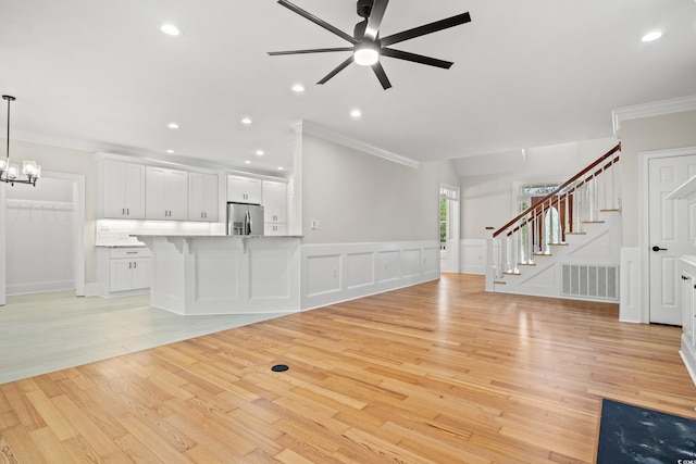 1533 Murrells Landing Rd, Conway, SC 29526 - unfurnished living room with ornamental molding, a ceiling fan, stairway, light wood finished floors, and a chandelier