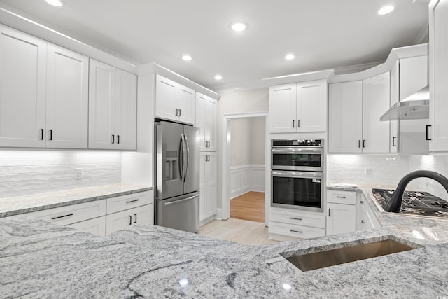 1533 Murrells Landing Rd, Conway, SC 29526 - kitchen with appliances with stainless steel finishes, extractor fan, white cabinetry, light stone countertops, and recessed lighting